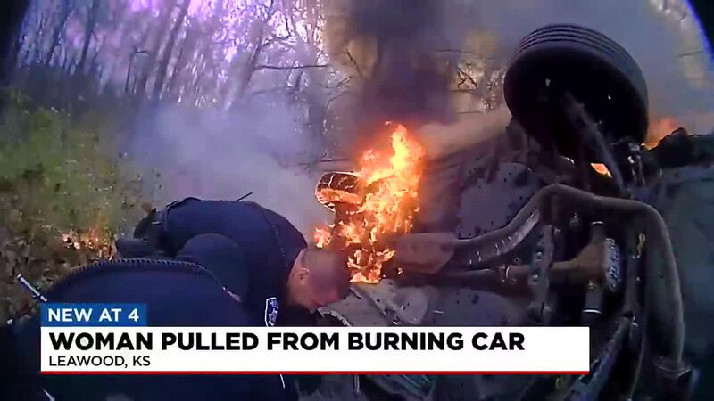 The authorities have released bodycam video of a woman being pulled from a burning vehicle...