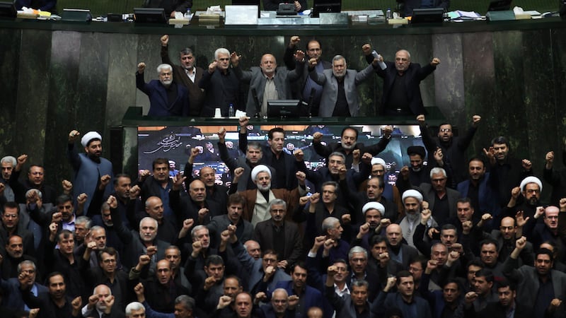FILE - Iranian lawmakers chant anti-American and anti-Israeli slogans to protest against the...