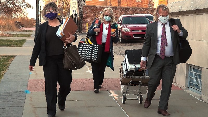 Jacqie Spradling, left, arrives with her legal team Monday, Dec. 7, 2020, for a hearing into...
