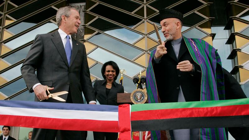 FILE - In this March 1, 2006 file photo, U.S. President George W. Bush, left, and Afghan...