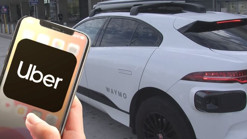Uber logo on a cell phone, and a Waymo car packed in downtown Phoenix.