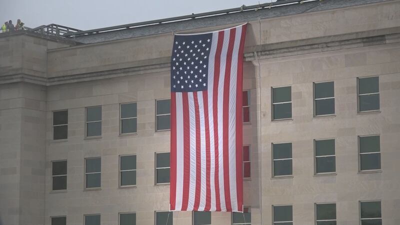FILE - A flag draped over the side of the Pentagon.