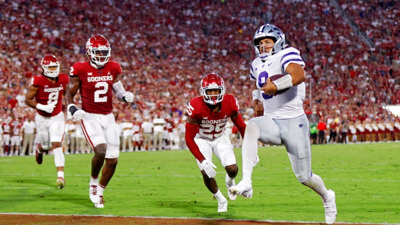 Kansas State quarterback Adrian Martinez (9) carries the ball for a touchdown past Oklahoma...