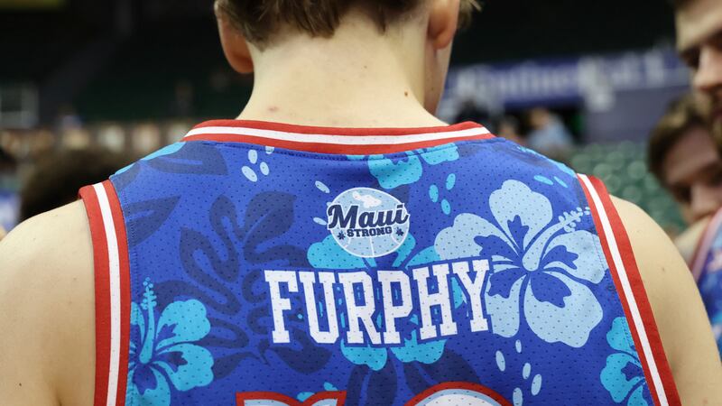 A "Maui Strong" emblem adorns the back of Kansas guard Johnny Furphy's uniform before an NCAA...