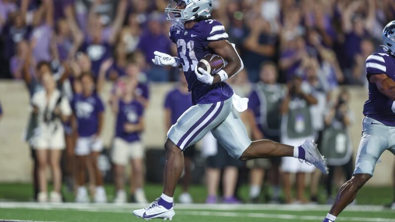 Kansas State running back DJ Giddens scores a touchdown during the first half of an NCAA...