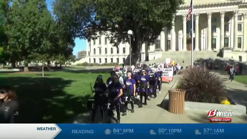 Demonstrators march from the Kansas statehouse to the YWCA in the Week without Violence march...