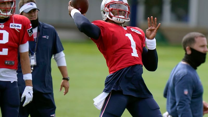 New England Patriots quarterback Cam Newton throws during an NFL football training camp...