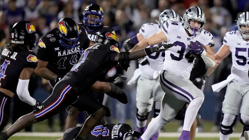 Kansas State tight end Ben Sinnott (34) is chased by Kansas safety Kenny Logan Jr. (1) during...