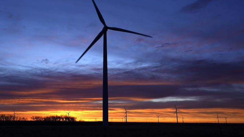 FILE - In this Jan. 13, 2021, file photo, wind turbines are silhouetted against the sky at...