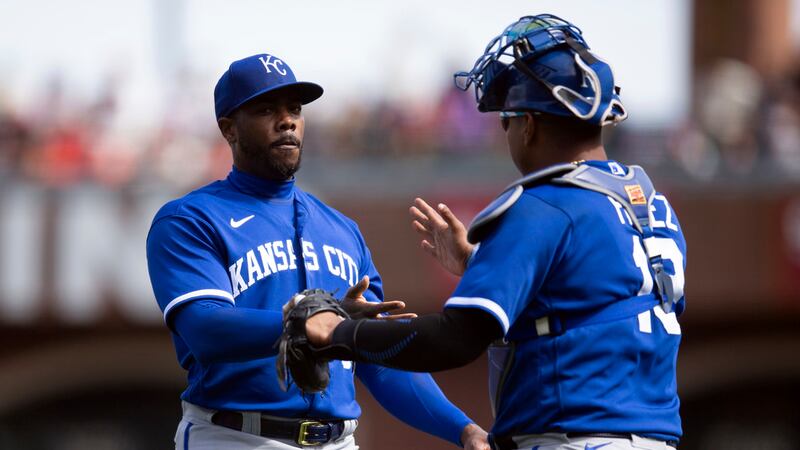 Kansas City Royals catcher Salvador Perez, right, congratulates pitcher Aroldis Chapman after...