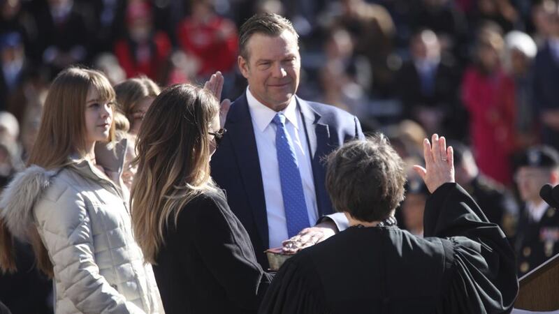 FILE - Republican Kris Kobach takes the oath of office as Kansas attorney general as his...