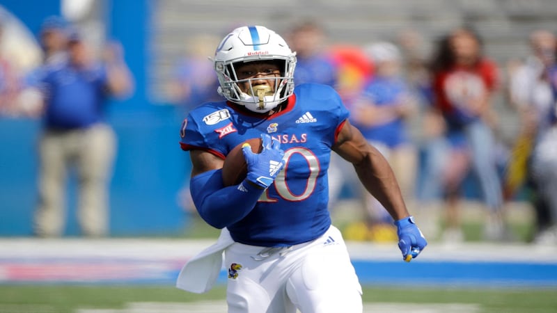 Kansas running back Khalil Herbert runs for a first down during the first half of an NCAA...
