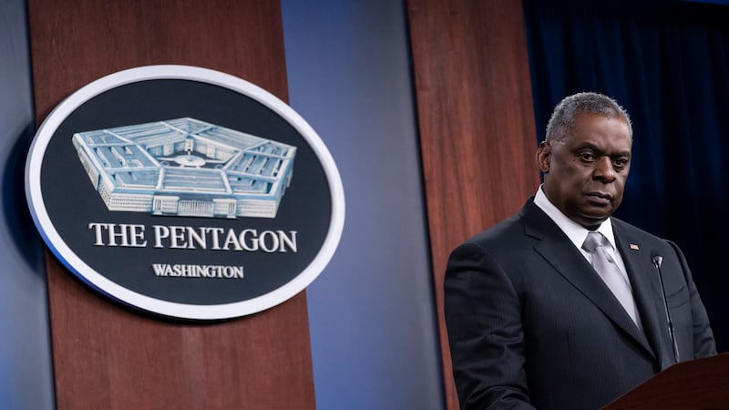 Secretary of Defense Lloyd Austin listens to a question as he speaks during a media briefing...