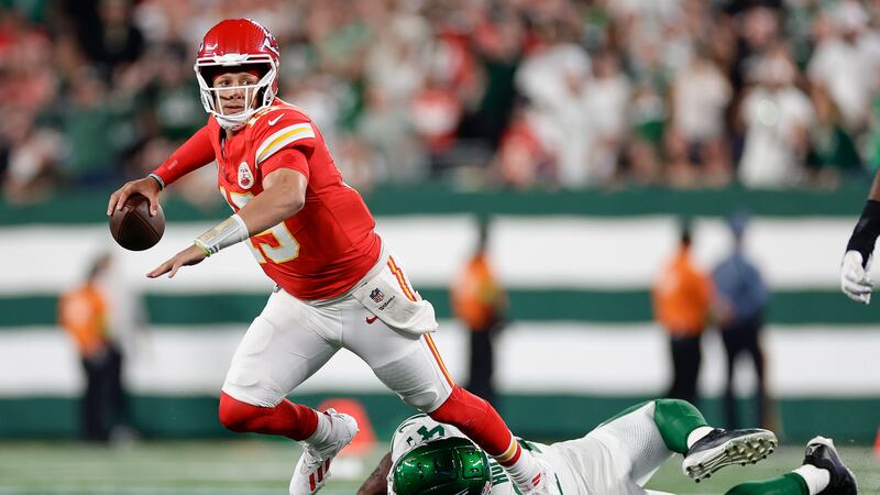 Kansas City Chiefs quarterback Patrick Mahomes (15) is tripped up by New York Jets linebacker...